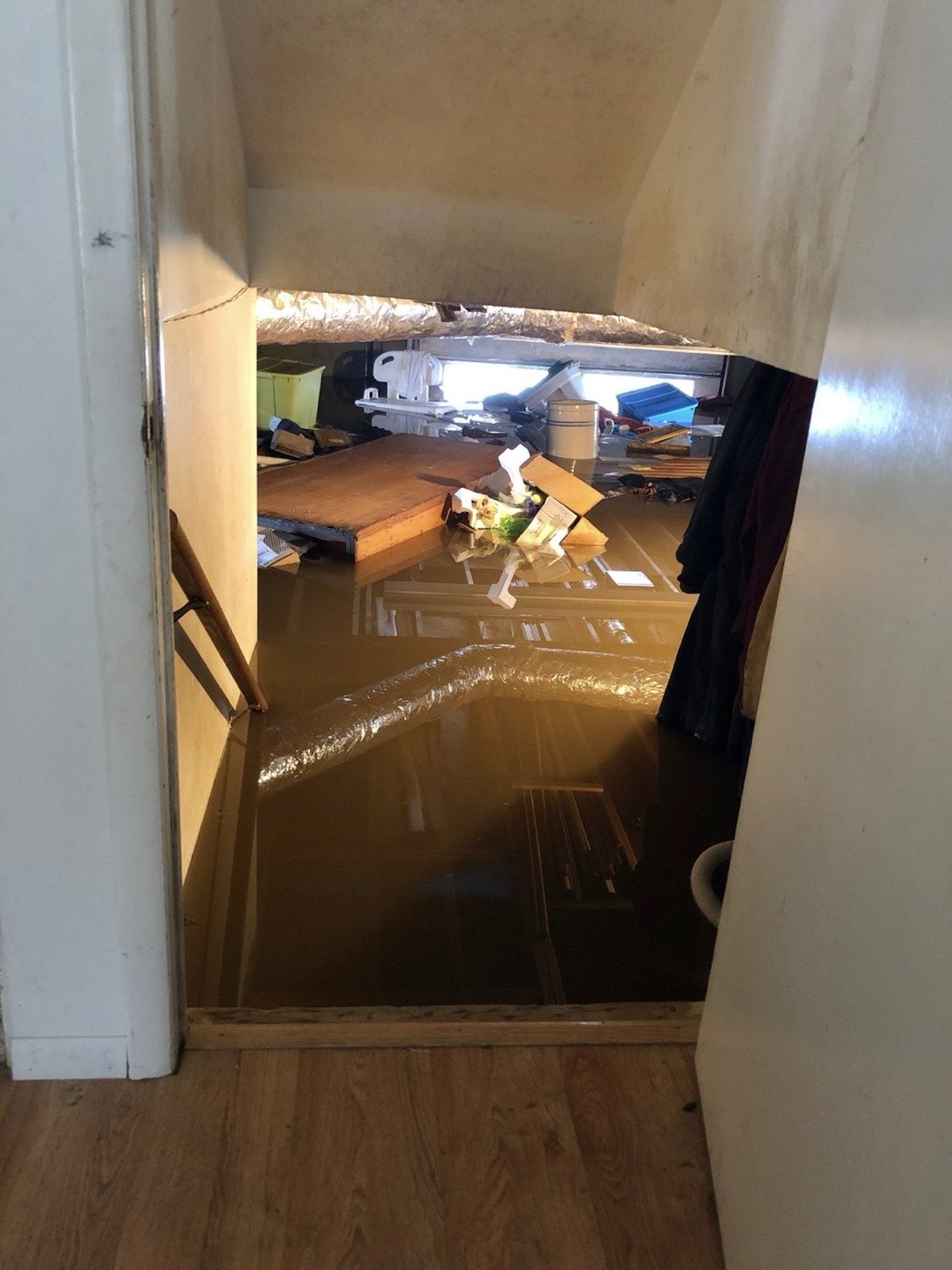 Standing water covering a home's floor after a washing machine overflow