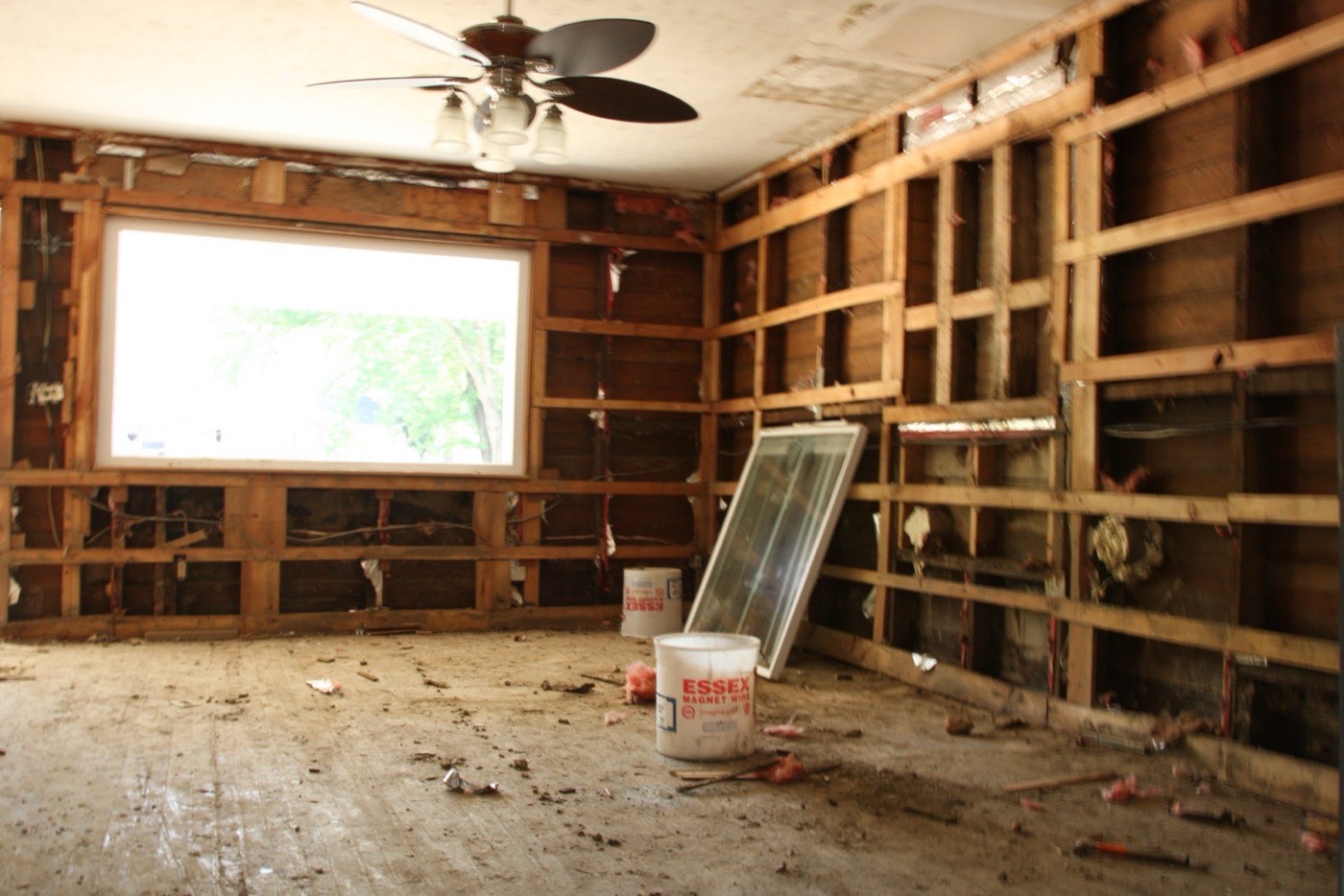 Damaged home interior with insulation removed from the walls after water damage, the kind of loss that leads to a water damage insurance claim